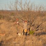 Two bird hunters in Texas with bird dog.