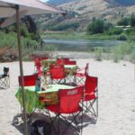 Mobile dining area set up on river beach.